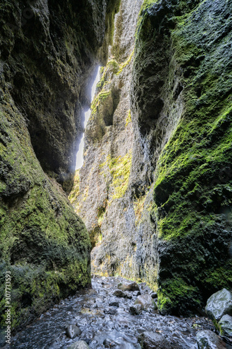 volcanic cave of Gljufrafoss with a little creek in Iceland