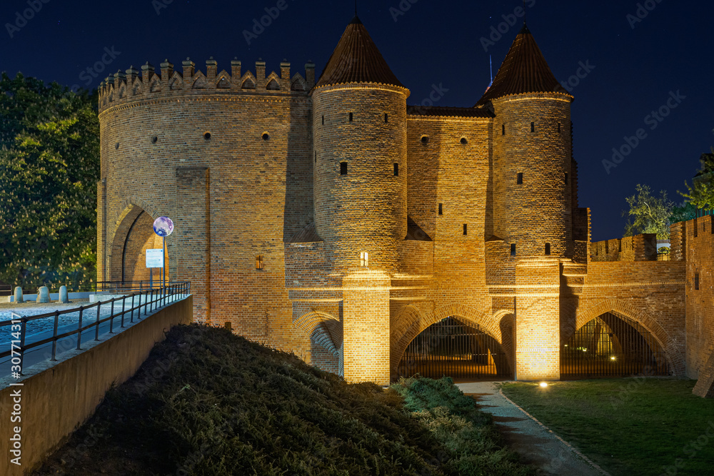 Night view at Old Town with Warsaw Barbican fortress, Poland