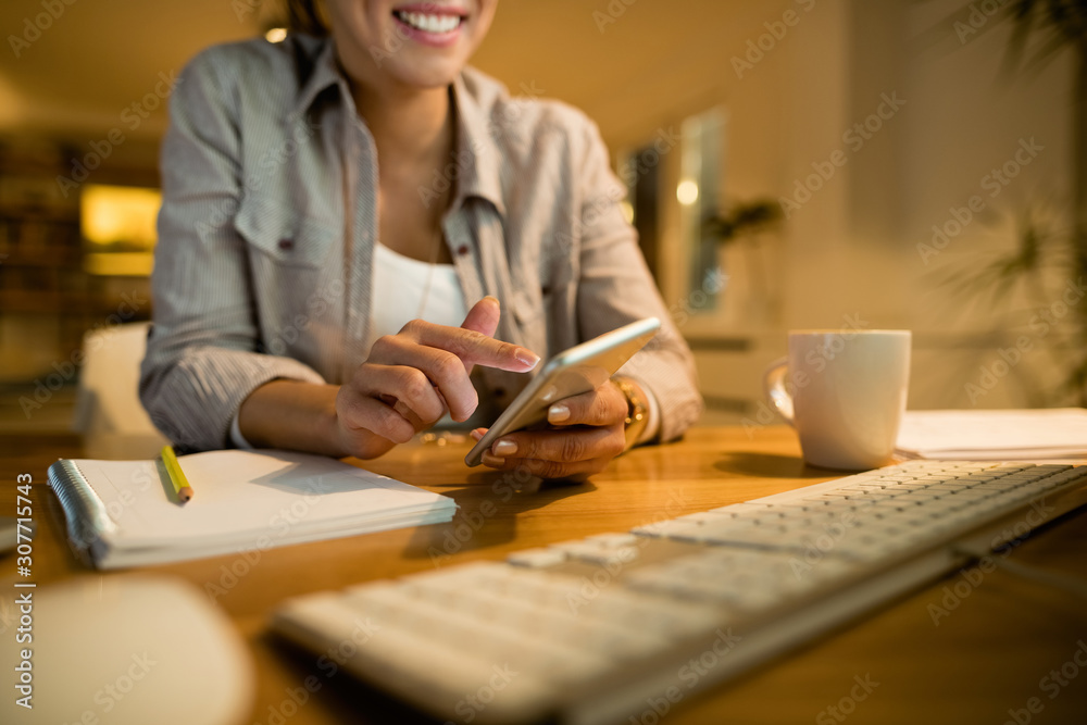 Unrecognizable woman using cell phone and text messaging at home. Unrecognizable woman using cell phone and text messaging at home.
