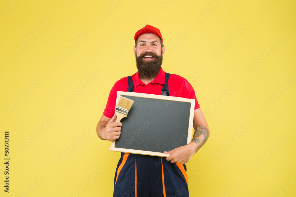 Repair and renovation. Repair tips. Man worker with paint brush. Builder regular worker. Quick repair. Creative decorator. Painting works. Bearded decorator laborer hold blackboard copy space Repair and renovation. Repair tips. Man worker with paint brush. Builder regular worker. Quick repair. Creative decorator. Painting works. Bearded decorator laborer hold blackboard copy space