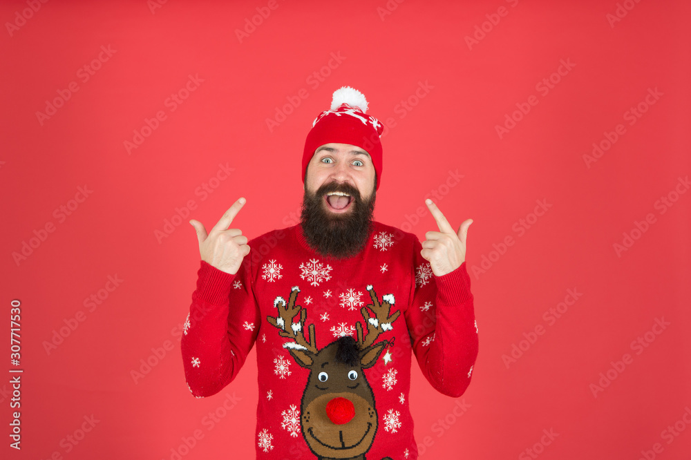 Hipster cheerful bearded man wear winter sweater and hat. Happy new year. Join holiday party craze and host ugly christmas sweater party. Feeling awesome. Buy festive clothing. Sweater with deer