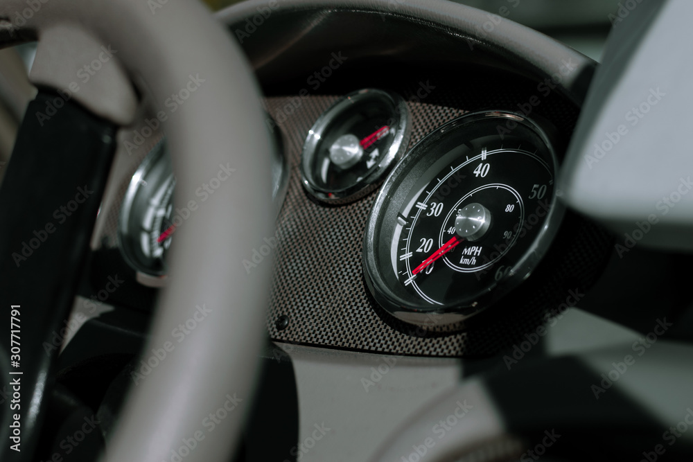 Dashboard of a fishing boat. Steering wheel, speedometer, tachometer and trim level