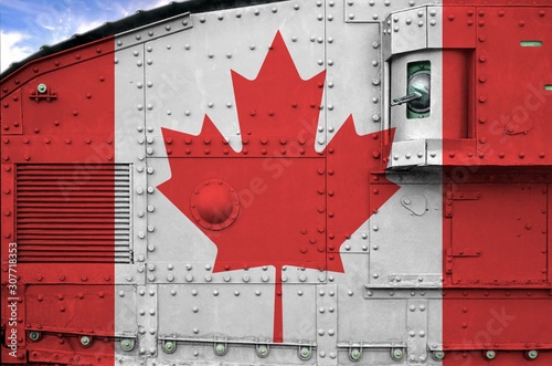 Canada flag depicted on side part of military armored tank closeup. Army forces conceptual background photo