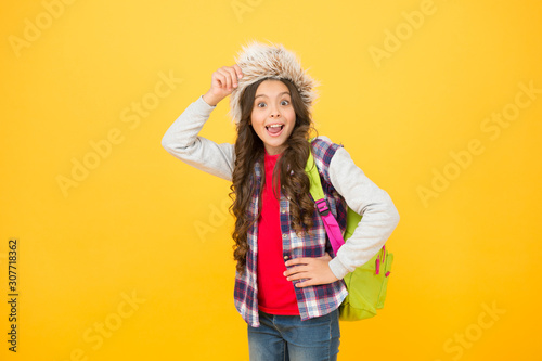 Kid girl wear hat with ear flaps. Winter vacation. Submit learning goals reflections for semester. Winter events at school. Winter entertainment and activities. Child schoolgirl soft hat enjoy season