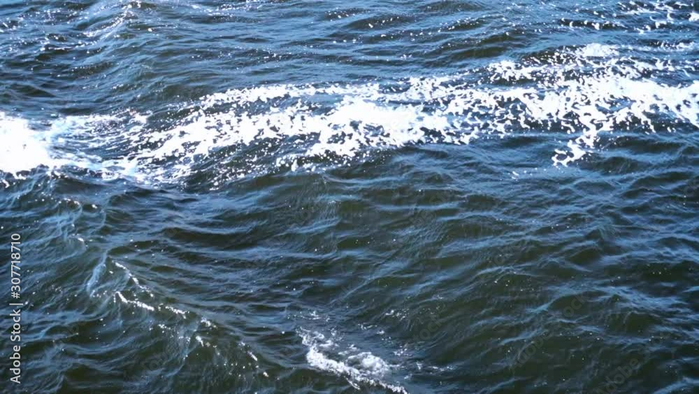 The surface of the river, small waves and foam on the surface. The surface of the river, small waves and foam on the surface.