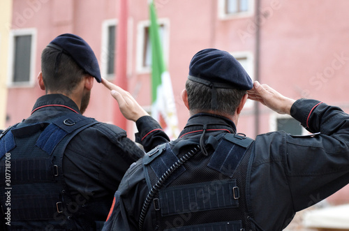 Italian soldiers saluting flag of Italy. Carabinieri saluting Italian flag. Italian Armed Forces photo