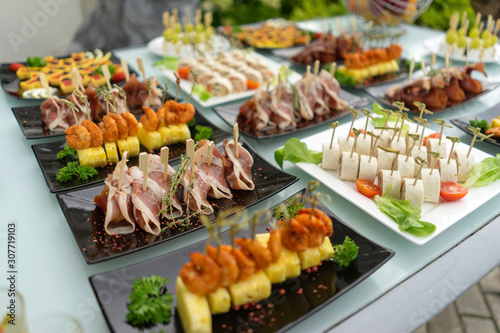 Fototapeta Naklejka Na Ścianę i Meble -  The classic Spanish hamon. Food delivery service and catering meals on the table during the event.