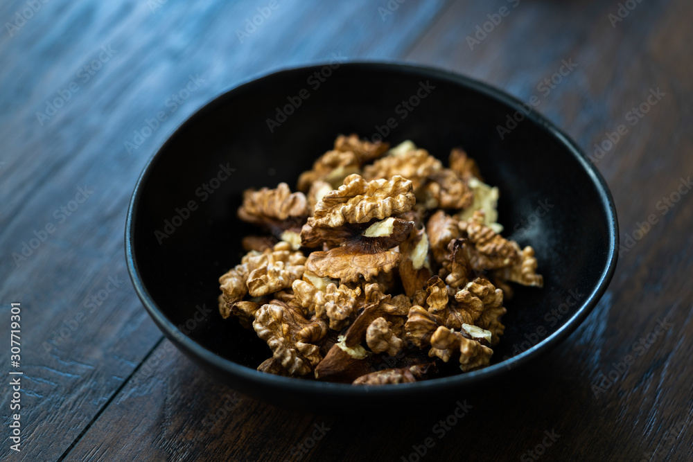 Walnut Kernels and Whole walnuts in Porcelain Bowl. Walnut Kernels and Whole walnuts in Porcelain Bowl.
