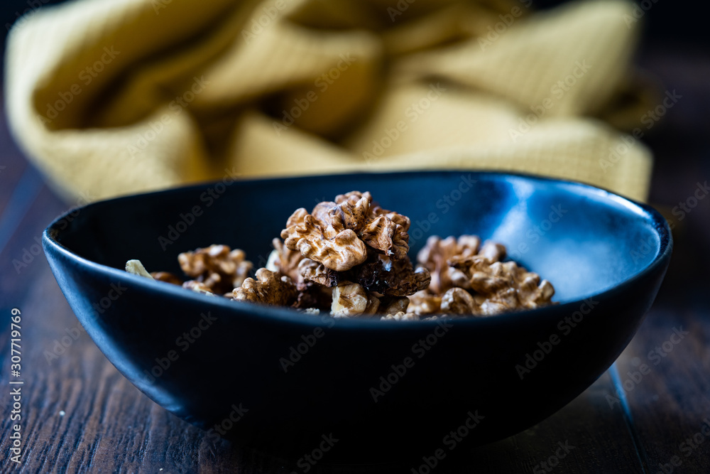 Walnut Kernels and Whole walnuts in Porcelain Bowl. Walnut Kernels and Whole walnuts in Porcelain Bowl.