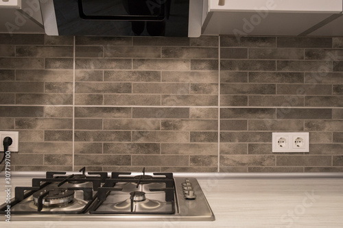 Obraz na plátně modern kitchen interior with stainless steel gas cook-top and grey tile brick ba