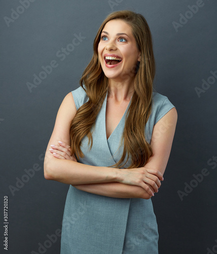 Happy woman with crossed arms, long hair and toothy smile.
