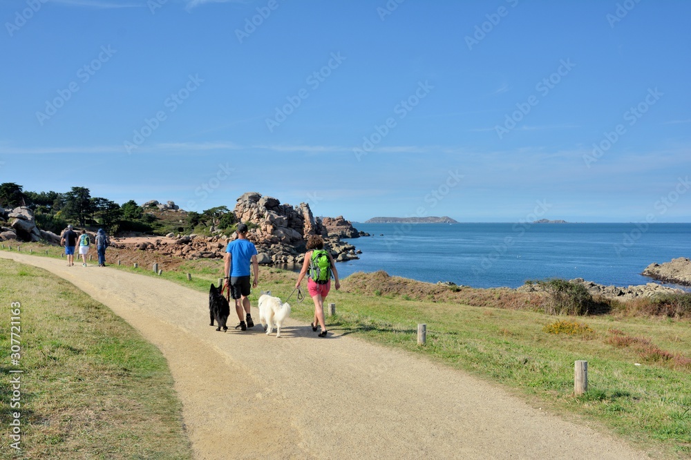 A couple who is walking on a path at seaside in Brittany. France