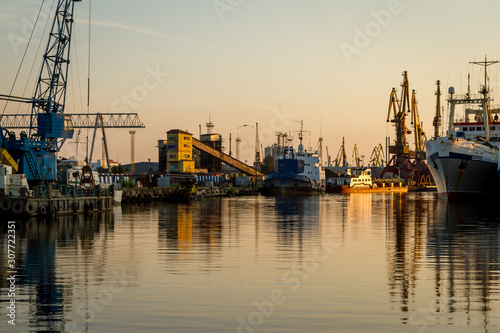 Russia, Kaliningrad, hoisting cranes in the commercial port at sunset