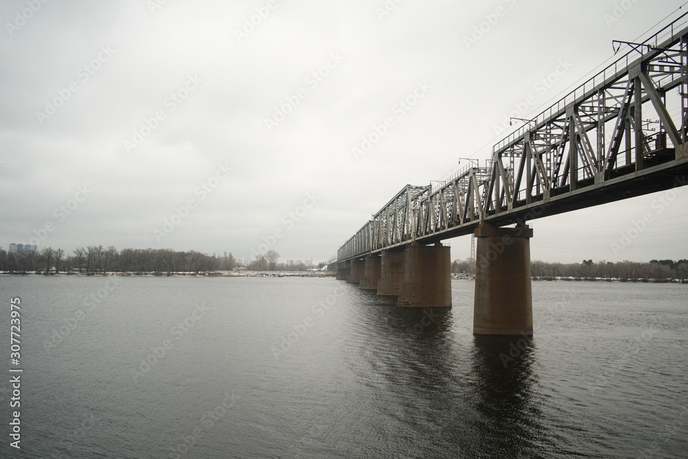 Railway bridge over Dnipro river in Kyiv. Industrial steel bridge across the river. Railway bridge over Dnipro river in Kyiv. Industrial steel bridge across the river.