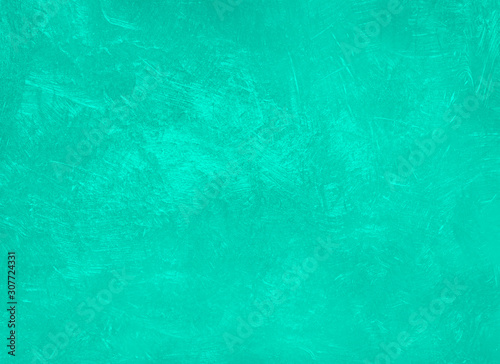 Concrete texture toned in the trendy color Aqua Menthe. Stucco wall background.