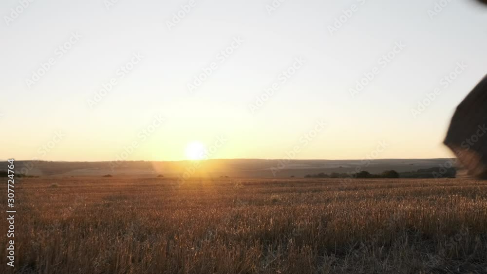 Slow motion happy boy running on summer meadow against backdrop of sunset of summer day, holding plane in his hand, playing in light of the bright sun. Child lifestyle. Lens flare. Lifestyle Slow motion happy boy running on summer meadow against backdrop of sunset of summer day, holding plane in his hand, playing in light of the bright sun. Child lifestyle. Lens flare. Lifestyle
