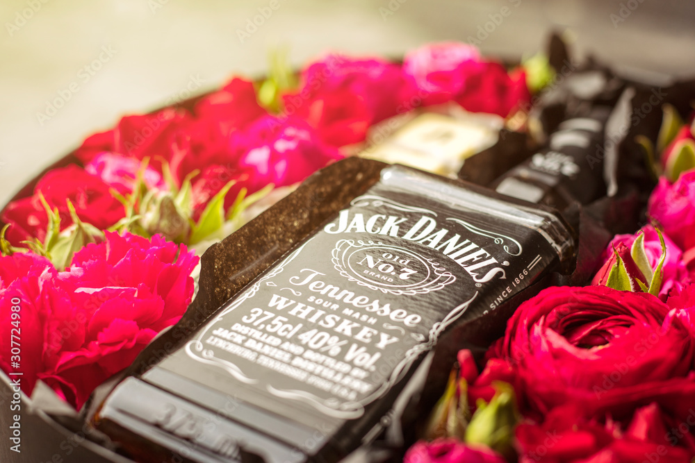 gift wrapping of JackDaniels whiskey. Flowers and alcohol Photos | Adobe  Stock
