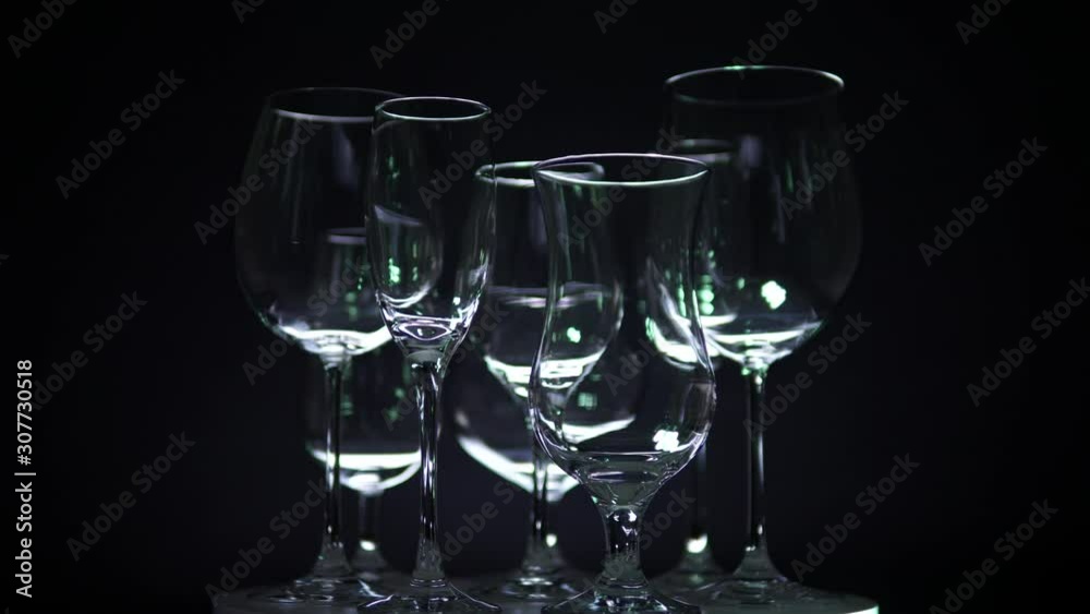 Various shaped champagne and alcohol beverages glasses on the buffet table, the hall of the restaurant or night club concept. Close-up on the counter. New year or Christmas preparation concept. Various shaped champagne and alcohol beverages glasses on the buffet table, the hall of the restaurant or night club concept. Close-up on the counter. New year or Christmas preparation concept.