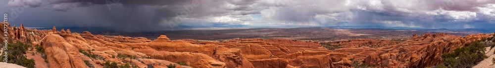 Panorama View of a Rain storm over The Devil's Garden, Arches National Park, Utah, USA.