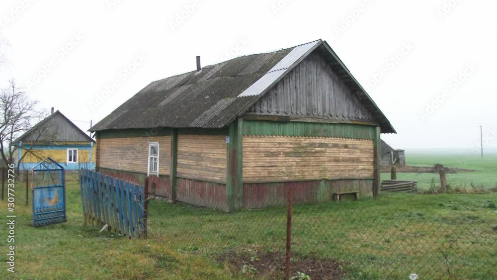 Old wooden house, a Residential village house in a forest village, combined from different roof coating Old wooden house, a Residential village house in a forest village, combined from different roof coating