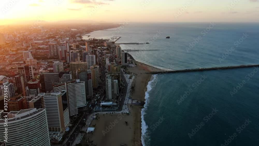Aerial view of city Fortaleza. Luxury resorts and hotels, skyscrapers on the coast line. Beautiful beaches. City view during sunset. 