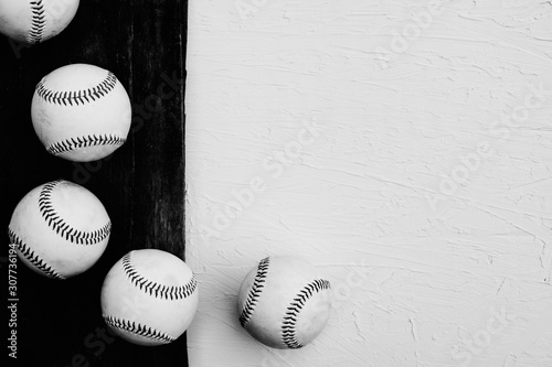 Canvas Print Rustic baseball background in black and white with top view of balls on wood, copy space for sports text