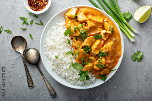 Chicken and cashew red curry with rice and herbs, thai inspired dish overhead view photo
