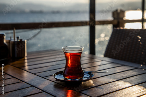 Photography Turkish tea against the sea on wooden table
