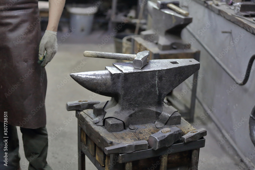 Heavy metal anvil in the forge for forging handmade products Heavy metal anvil in the forge for forging handmade products