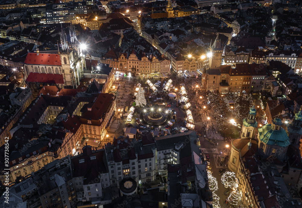 Prague, Czech Republic - Aerial view of the famous traditional Christmas market at Old Town Square at dusk with illuminated Church of our Lady Before Tyn and Old Town Hall at background Prague, Czech Republic - Aerial view of the famous traditional Christmas market at Old Town Square at dusk with illuminated Church of our Lady Before Tyn and Old Town Hall at background