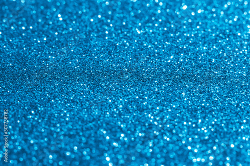 Blurred shiny Christmas lights toned blue color