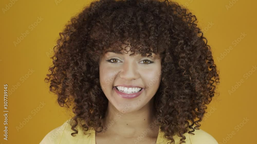 Beautiful brunette model smiling at camera. Beautiful teeth. Curly hair. Brazilian young woman. 4K. Beautiful brunette model smiling at camera. Beautiful teeth. Curly hair. Brazilian young woman. 4K.