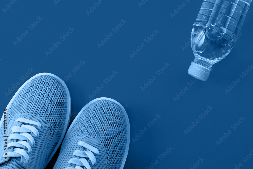 Bright orange sneakers on an orange background. Bright orange sneakers on an orange background.