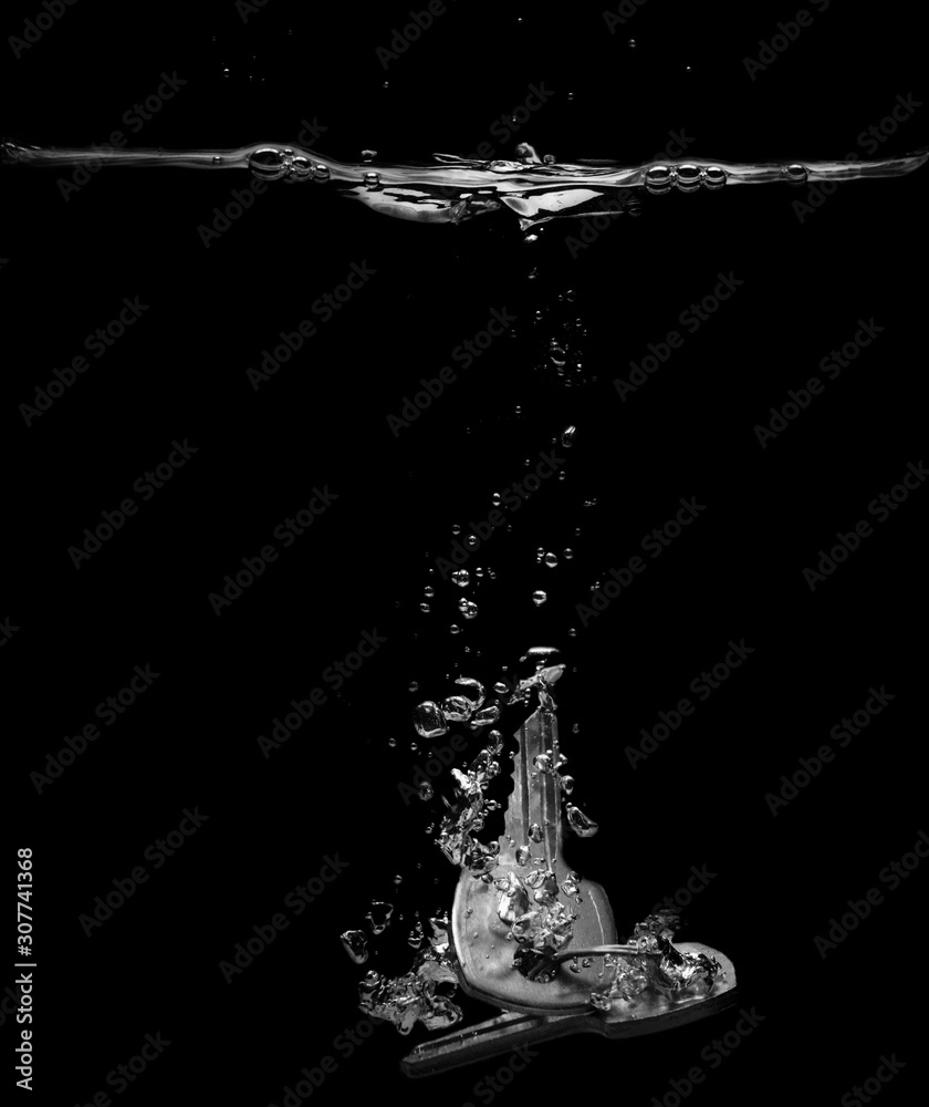 Drop keys into water on black background Drop keys into water on black background