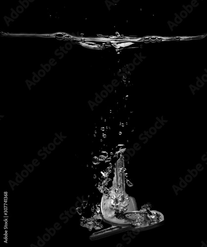 Drop keys into water on black background