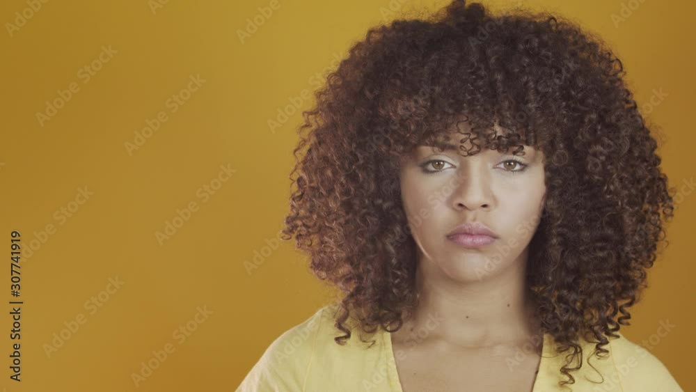 We can do it. Woman's fist of female power. Woman victim of racism. Abuse at work. The feminine power. Female empowerment. The strength of women. Yellow background. 4k.