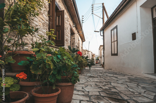 Fototapeta Naklejka Na Ścianę i Meble -  Beautiful narrow street of Pano Lefkara village, Cyprus with flower pots and masonry.