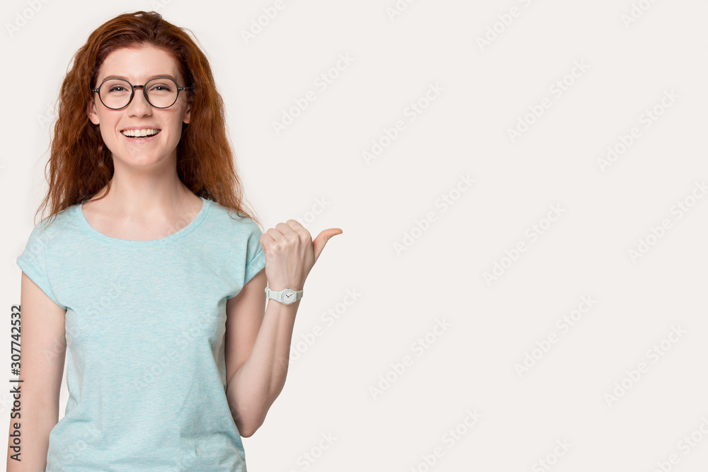 Smiling young woman pointing on blank copy space. Smiling young woman pointing on blank copy space.