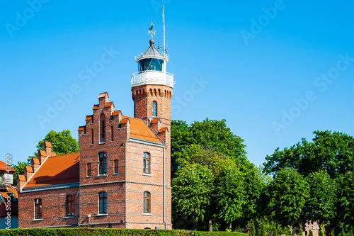 Old lighthouse in Ustka, Poland on a sunny summer day photo