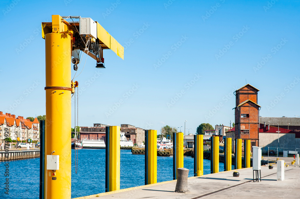 Yellow crane on a wharf in the harbor