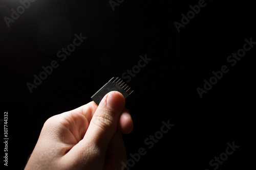 SD card in hand on a dark background