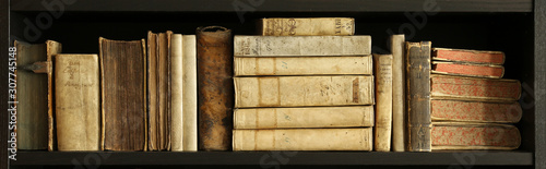 old books on wooden shelf.