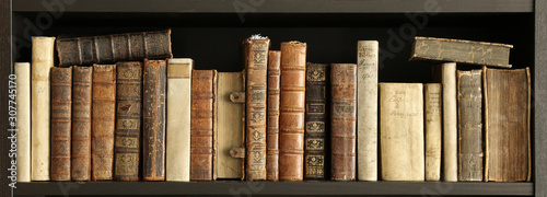 old books on wooden shelf. photo