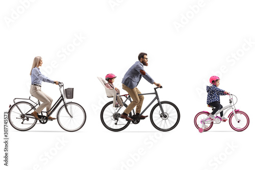 Active family of a mother, father with child in a seat and a little girl riding bicycles