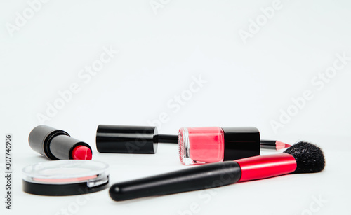 Set of woman make up cosmetics on white background. Beauty and fashion concept. On table lies lipstick, eye pencil, eye shadow, brushes. Fashionable Women's Cosmetics and Accessories.