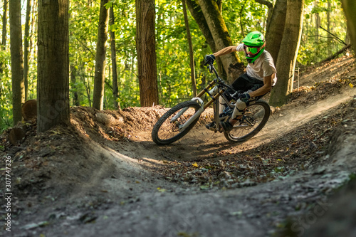Fototapeta Naklejka Na Ścianę i Meble -  Downhill mountain biker in motion crossing trails.