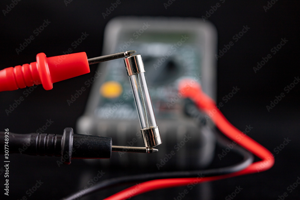 Electric meter and glass fuse. A device for measuring electric current and checking components. Electric meter and glass fuse. A device for measuring electric current and checking components.