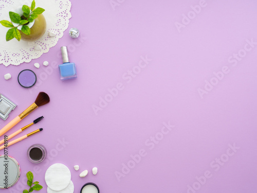 Fresh plant, makeup tools on purple