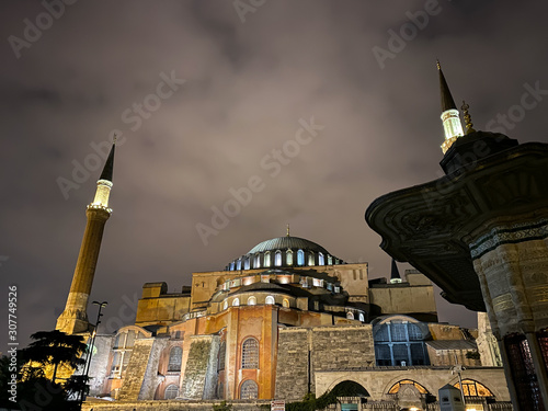 Ayasofya Museum, Hagia Sophia in Sultan Ahmet park in Istanbul, Turkey October 25, 2019 in a beautiful summer night scene and street lights. Ayasofya, outside at night with minaret photo