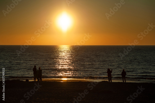 Rowy/Poland - June, 2019: People on the beach watching beaufiful sunset